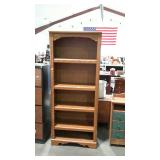 Four drawer wooden book shelf, measures 29 inches