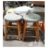Four wooden stools, 18" high, three have padded