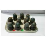 Tray with eleven glass insulators.