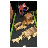 Decor items. Two wooden wagon figures and a metal