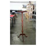 Tall plant stand or fish bowl stand. Some light