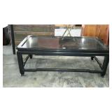 Black wooden coffee table with some surface wear,