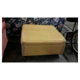 Oversized storage ottoman in yellow gold color.