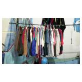 Two racks of clothing plus what is on wall