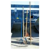 Four long handled yard tools. Two garden rakes,