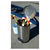 Metal trashcan with croquet mallets and toy bats