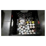 Two plastic crates with some golf balls