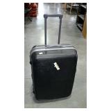Hard sided, wheeled suitcase with combination
