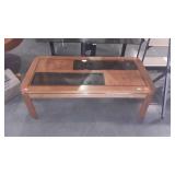 Wooden coffee table with glass sections, seller