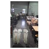 Metal clothing rack with bags, measures 73 inches