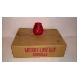 Case of twelve red knob by low boy candles. Some