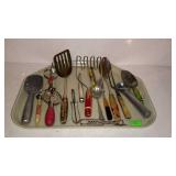 Tray of vintage kitchen utensils. Masher, mixer,