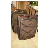 Two Jansport wheeled, soft sided suitcases.