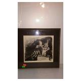 Framed black and white print of a lady sitting at