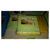 Three tablecloths in original packaging. One in