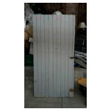 Painted barn door bottom of door has piece cut