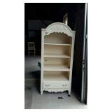 White bookshelf, has damage on rear leg but