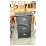 Three drawer stand on wheels. Drawers are fabric.