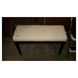 Long upholstered piano bench with storage.