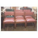 Set of six waiting room chairs, five are red and