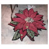 Two poinsettia shaped throw rugs