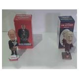 Two bobble heads one is Bruce Boudreau and the