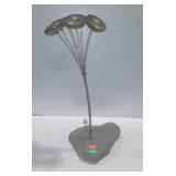 Wind chimes mounted in rock with coin medallion