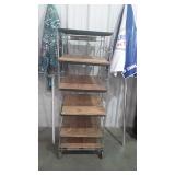 Metal framed storage rack on wheels with wooden