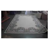 White rug with flower border, measures 132 inches