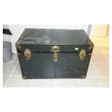 Trunk, with bed linens, located in down stairs