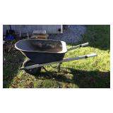 Metal wheel barrow, located in back yard