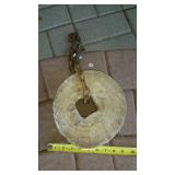 Grinding stone with some chain. Approximately 9"