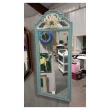 Tall wall mirror with painted wooden frame.