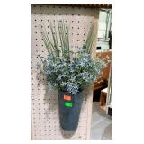 Tin wall pocket with faux flowers and greenery.