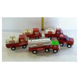 Toy trucks - three Coca-Cola, and two Texaco