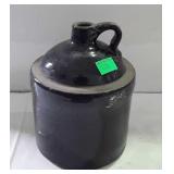Small black crock jug, measures 9 inches tall