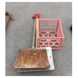 Two metal snow shovels and plastic crate
