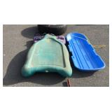 Two snow sleds, one is a Rubbermaid that does