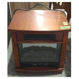 Small electric Infrared heater in the fireplace
