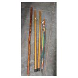 Three wooden walking sticks, and one umbrella
