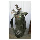 Golf bag with assorted Wilson golf clubs. Show
