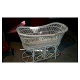 Early white wicker baby bassinet has some fraying