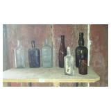 Seven glass bottles