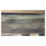 Heavy machete style knife with leather sheath.