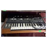Moog Prodigy electronic keyboard and mixer.