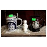 Two stein style mugs and small figurine.