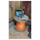 Two partial spools of wire. One is Internet cat 5E