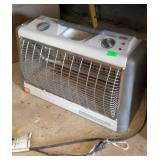 Portable electric heater shows shop dust and use