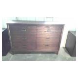 Six drawer brown dresser, front leg has been