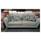 Two cushion sofa in neutral green color. Includes